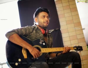Bhushan Poses Holding Guitar