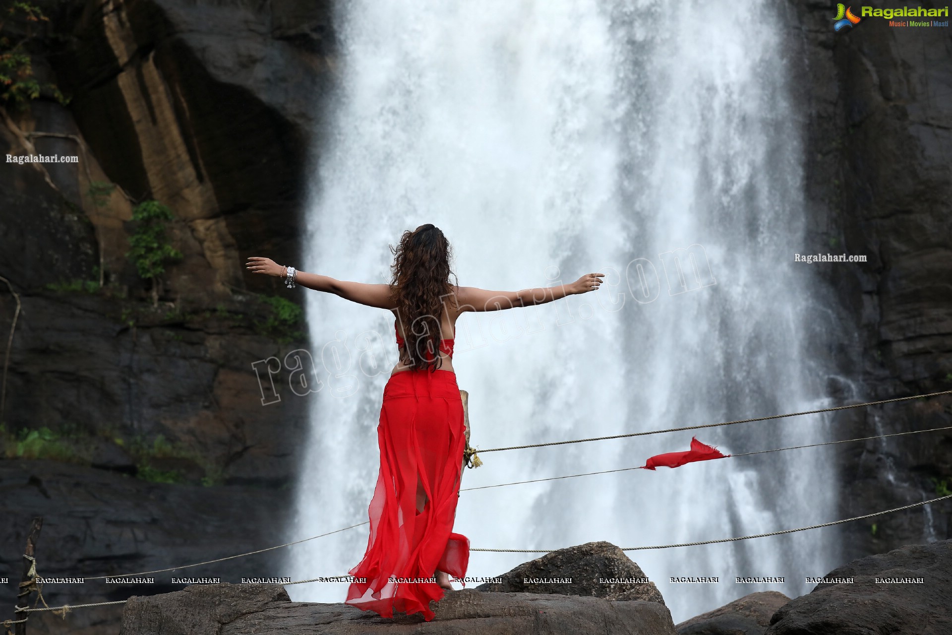 Payal Rajput Posing Provocatively in a Red Flowing Dress at a Waterfall, Exclusive