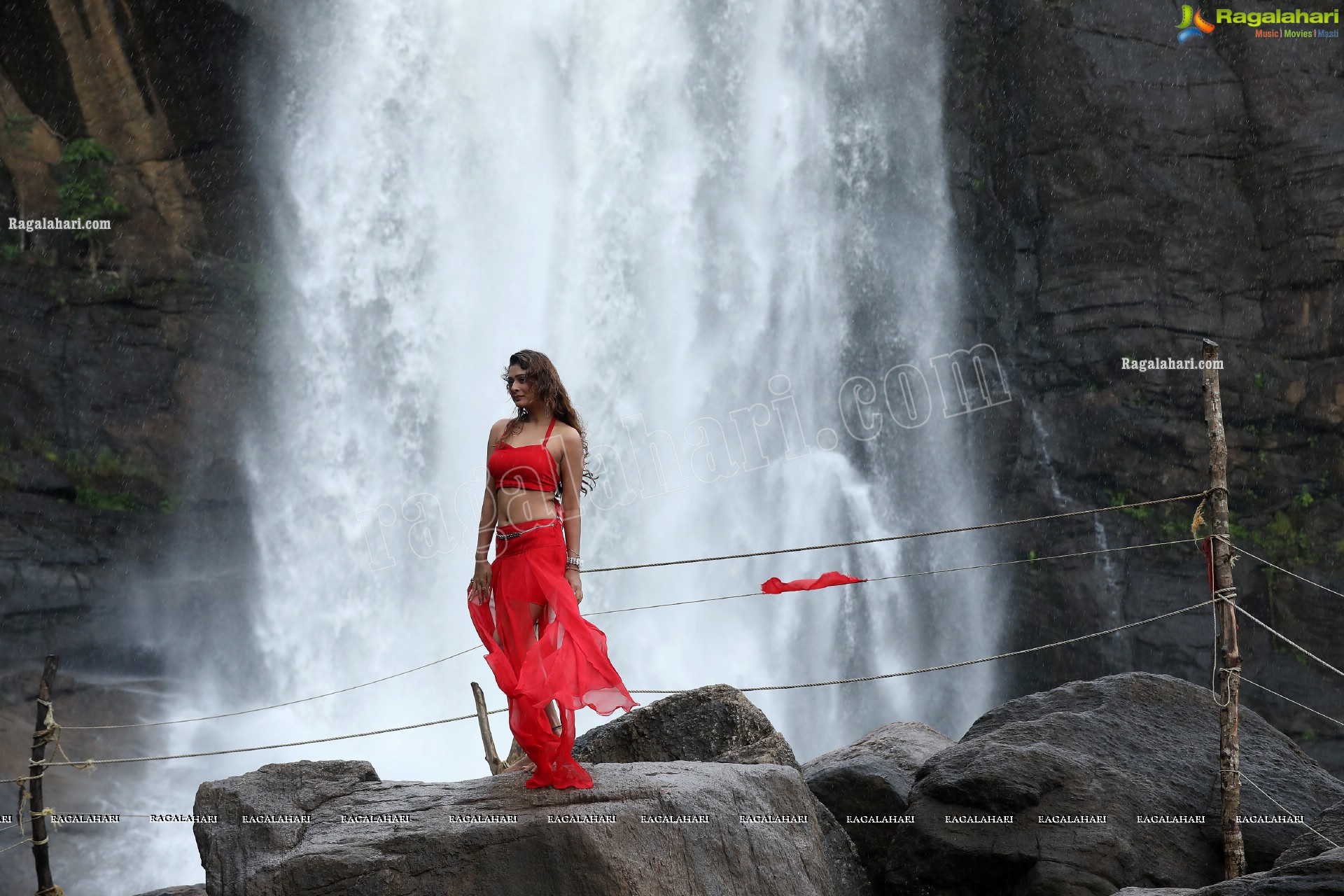 Payal Rajput Posing Provocatively in a Red Flowing Dress at a Waterfall, Exclusive