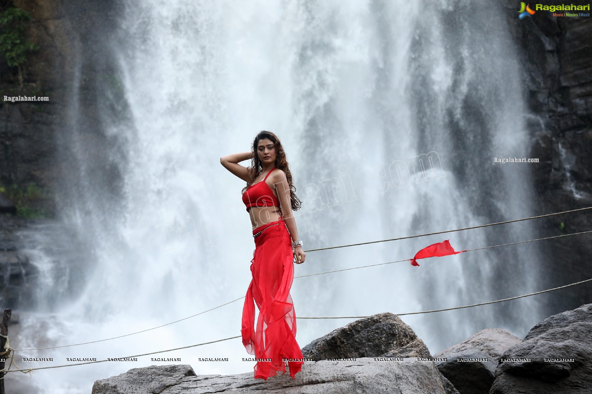 Payal Rajput Posing Provocatively in a Red Flowing Dress at a Waterfall, Exclusive