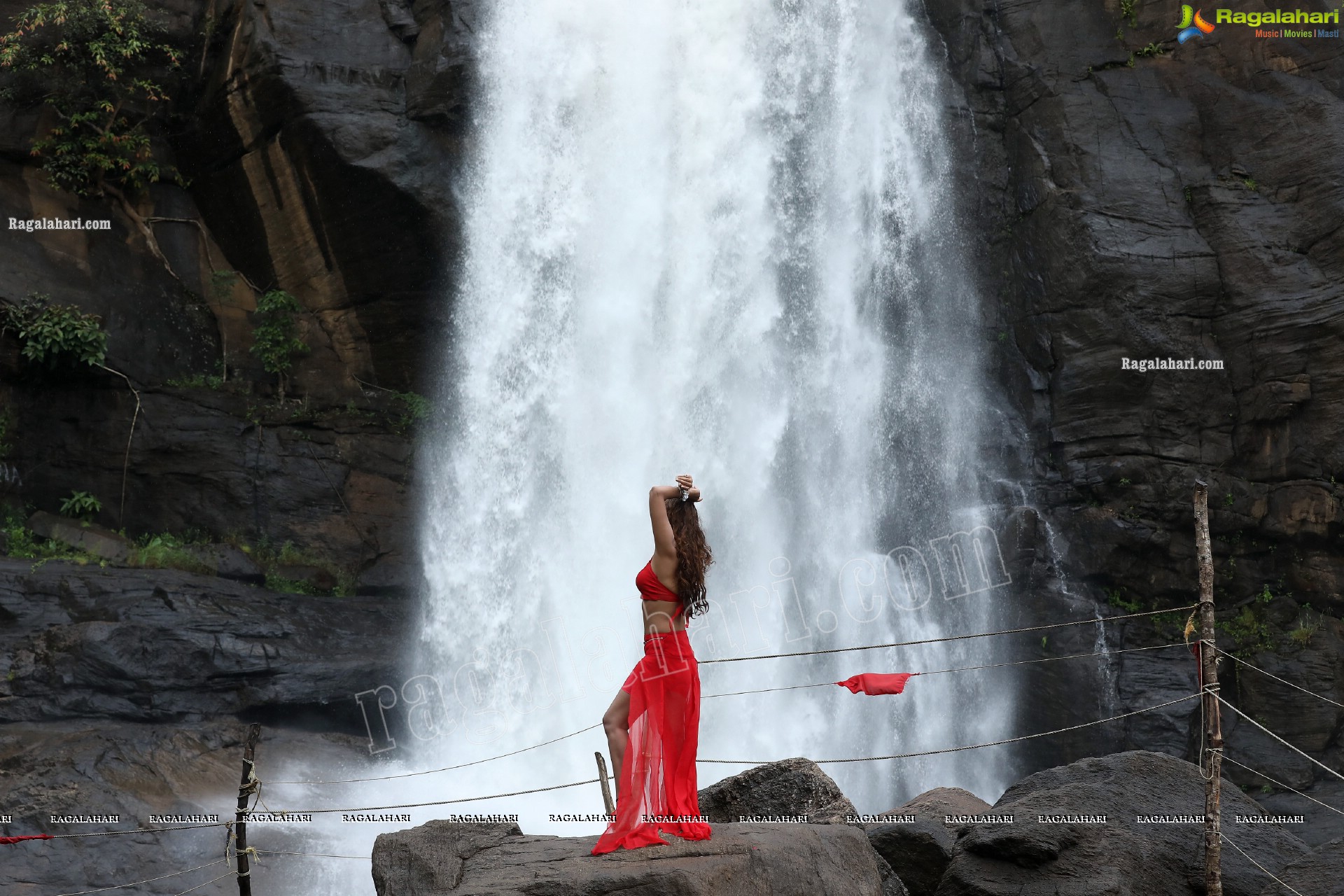 Payal Rajput Posing Provocatively in a Red Flowing Dress at a Waterfall, Exclusive