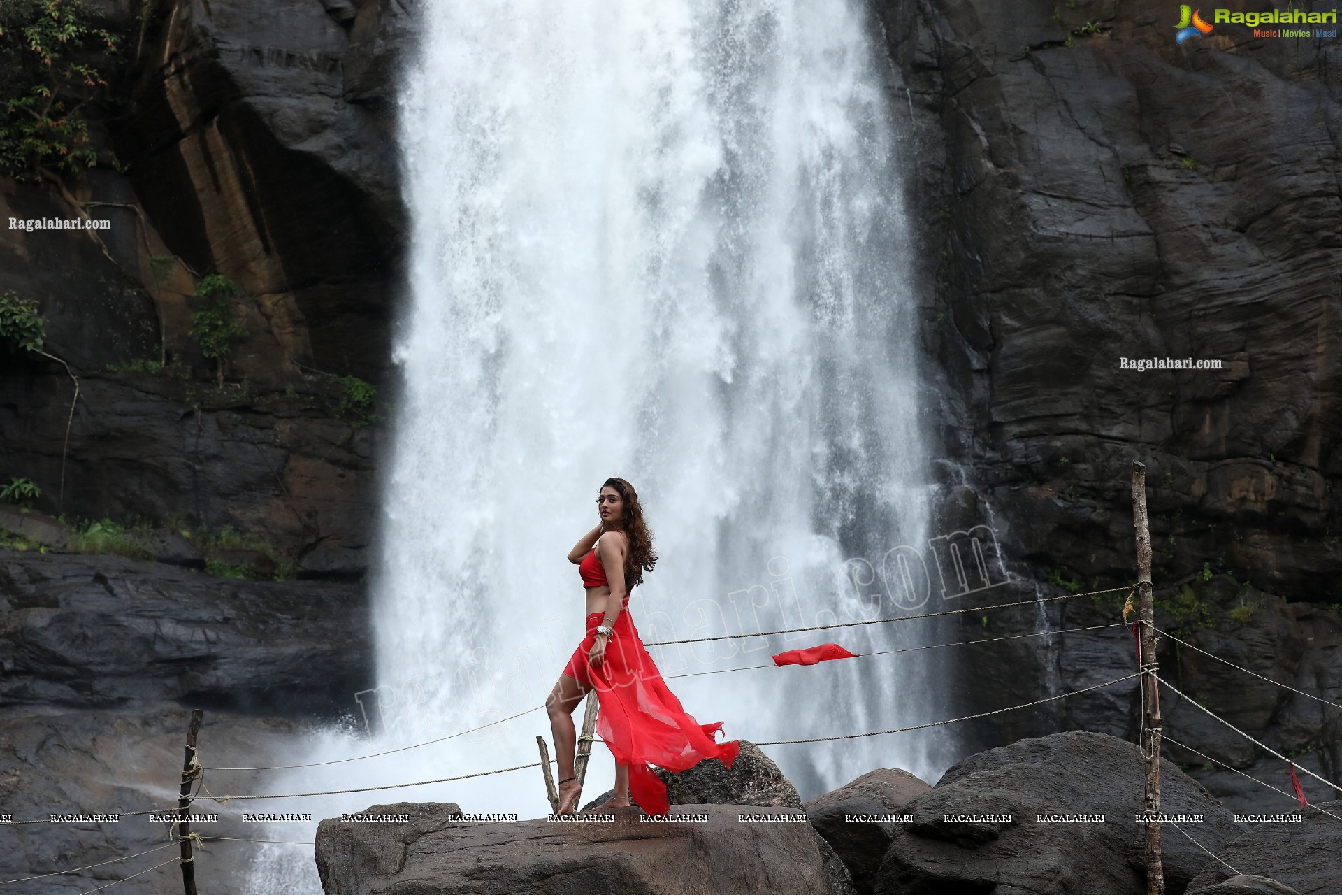 Payal Rajput Posing Provocatively in a Red Flowing Dress at a Waterfall, Exclusive