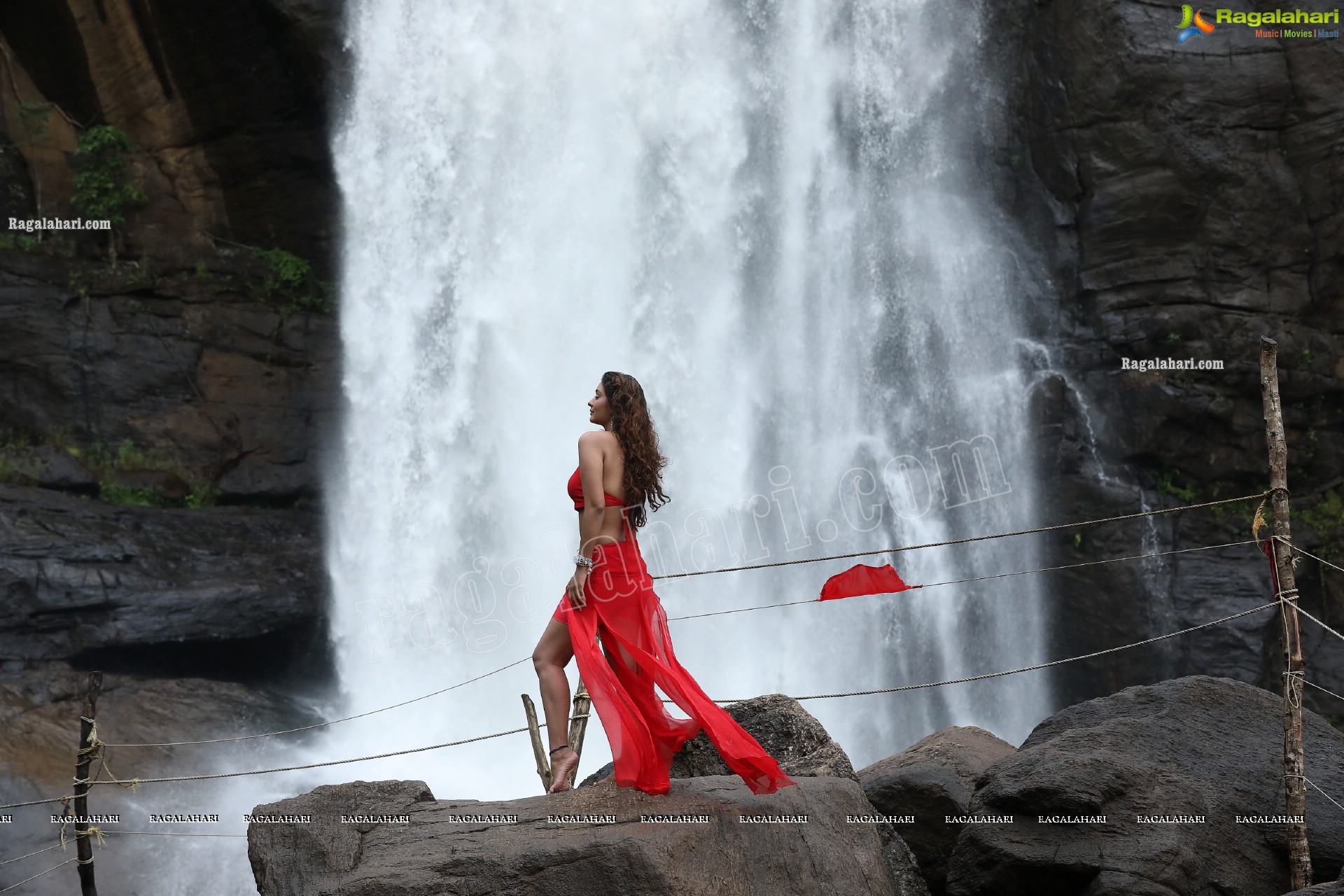 Payal Rajput Posing Provocatively in a Red Flowing Dress at a Waterfall, Exclusive