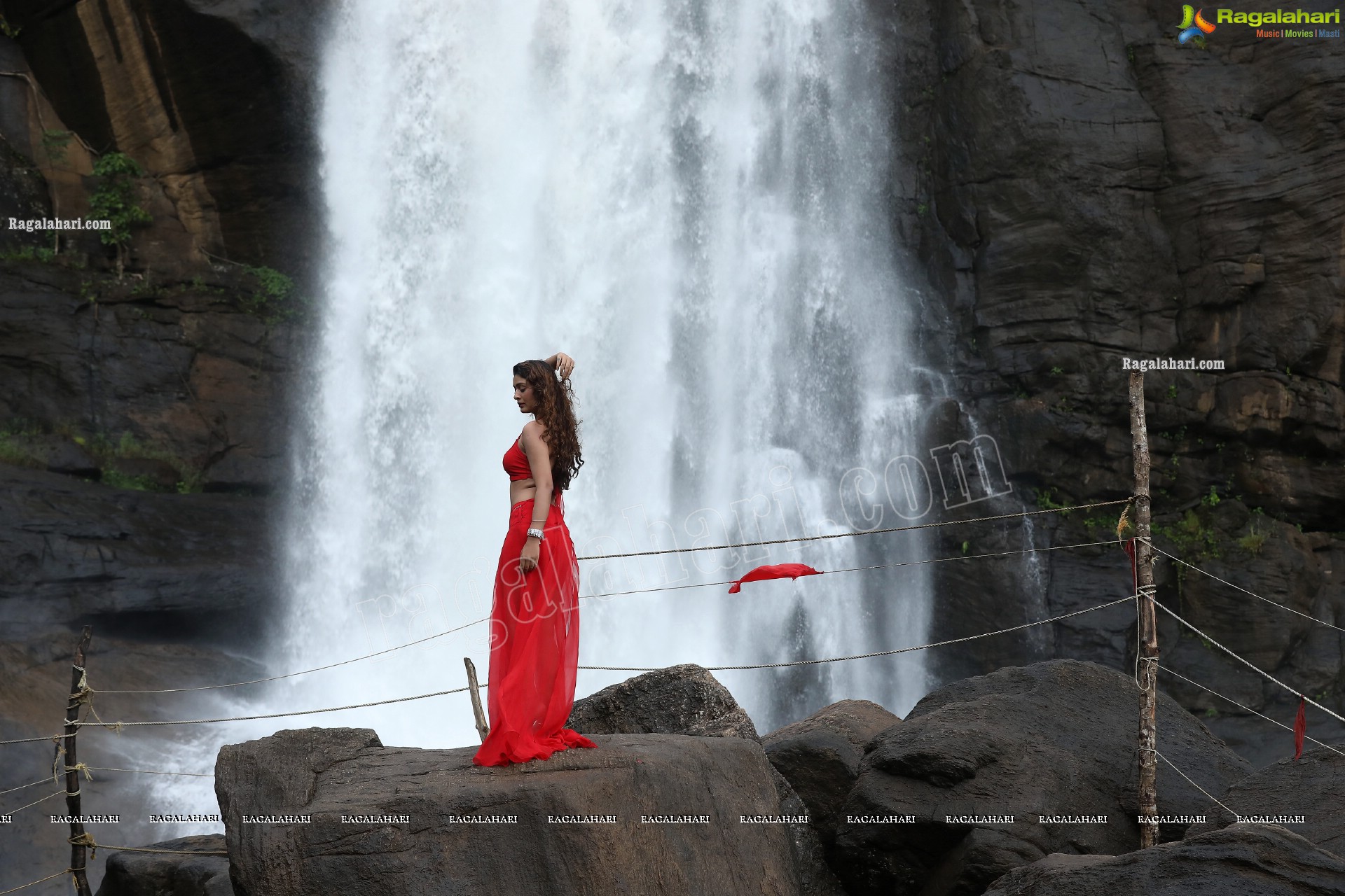 Payal Rajput Posing Provocatively in a Red Flowing Dress at a Waterfall, Exclusive