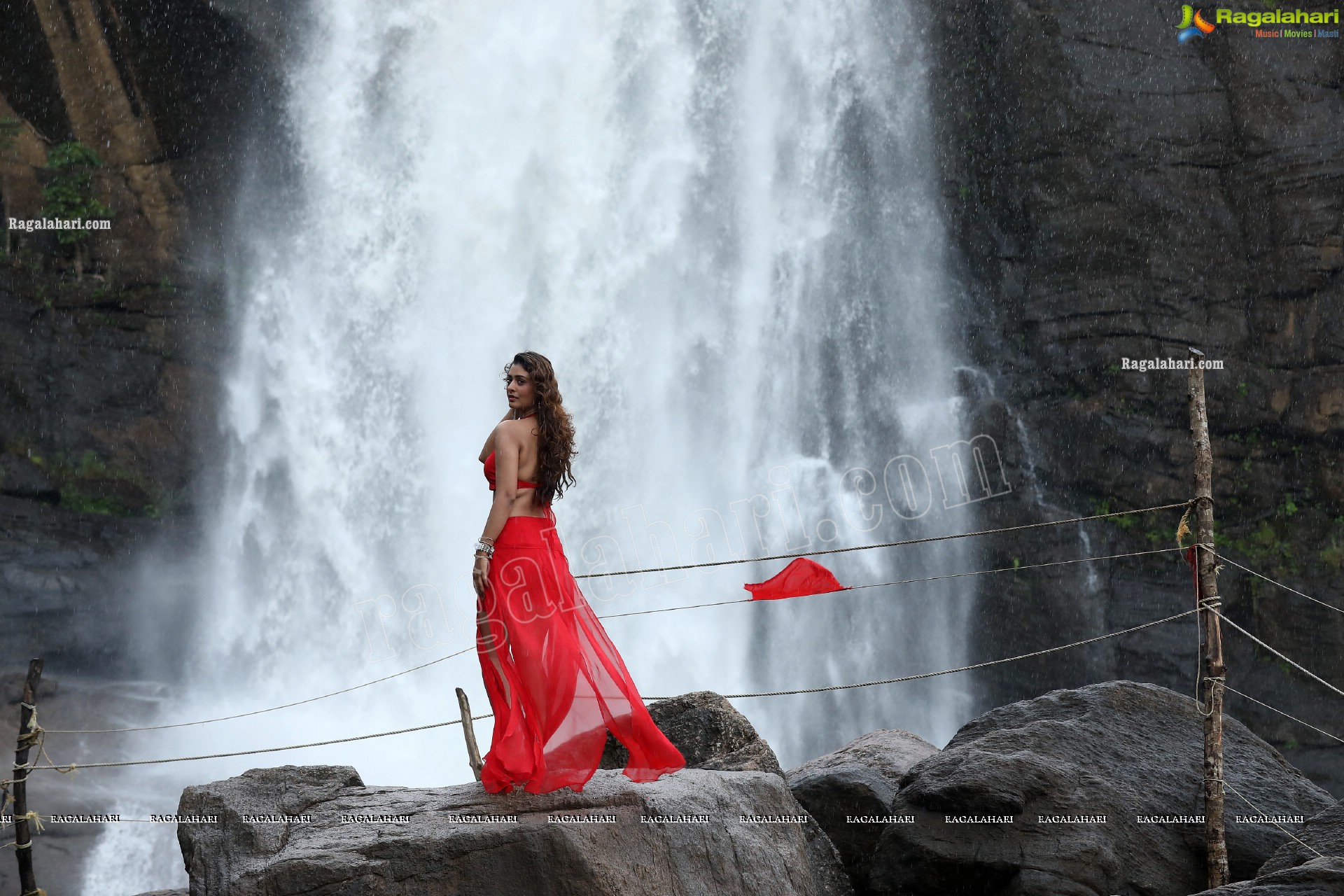 Payal Rajput Posing Provocatively in a Red Flowing Dress at a Waterfall, Exclusive
