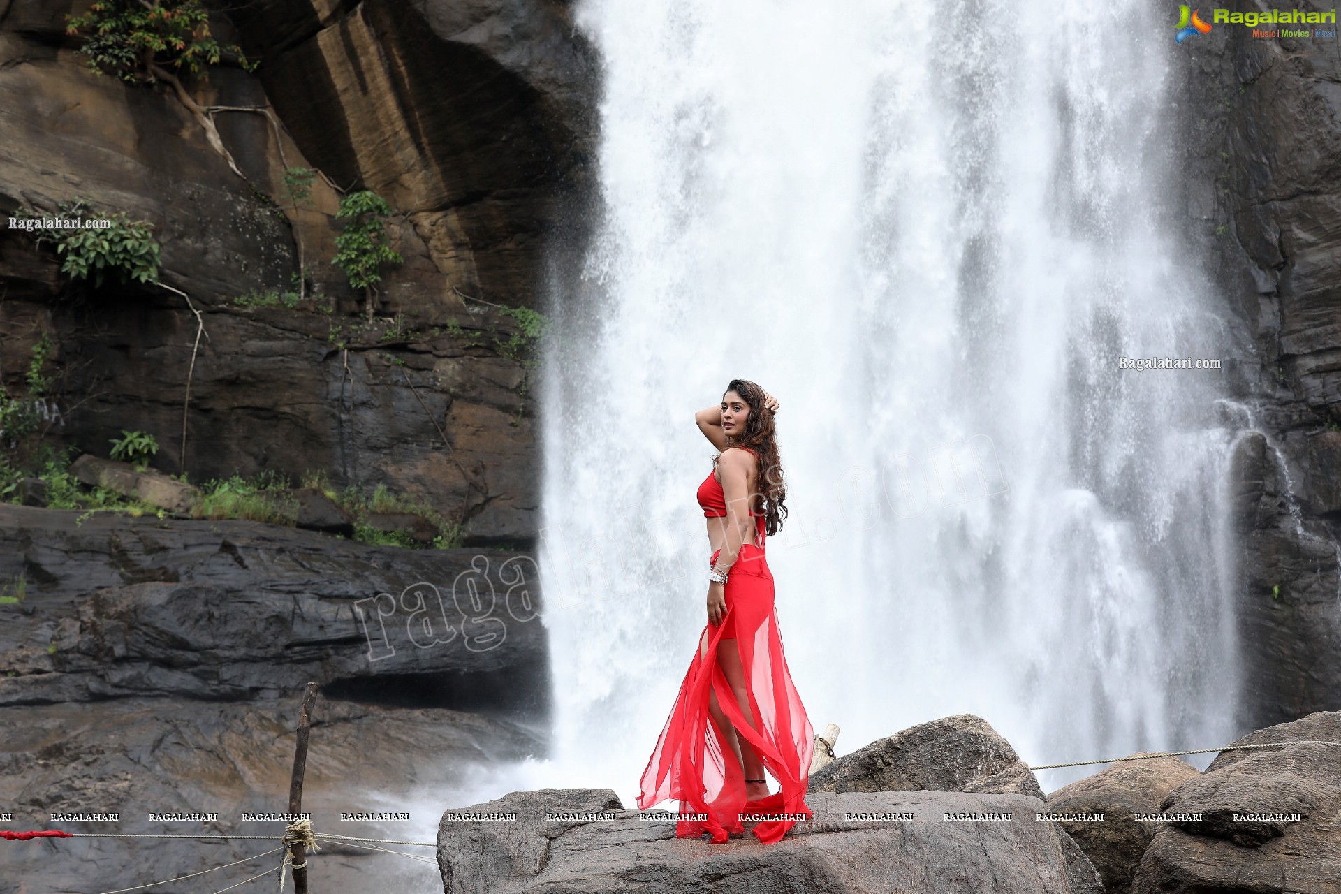 Payal Rajput Posing Provocatively in a Red Flowing Dress at a Waterfall, Exclusive