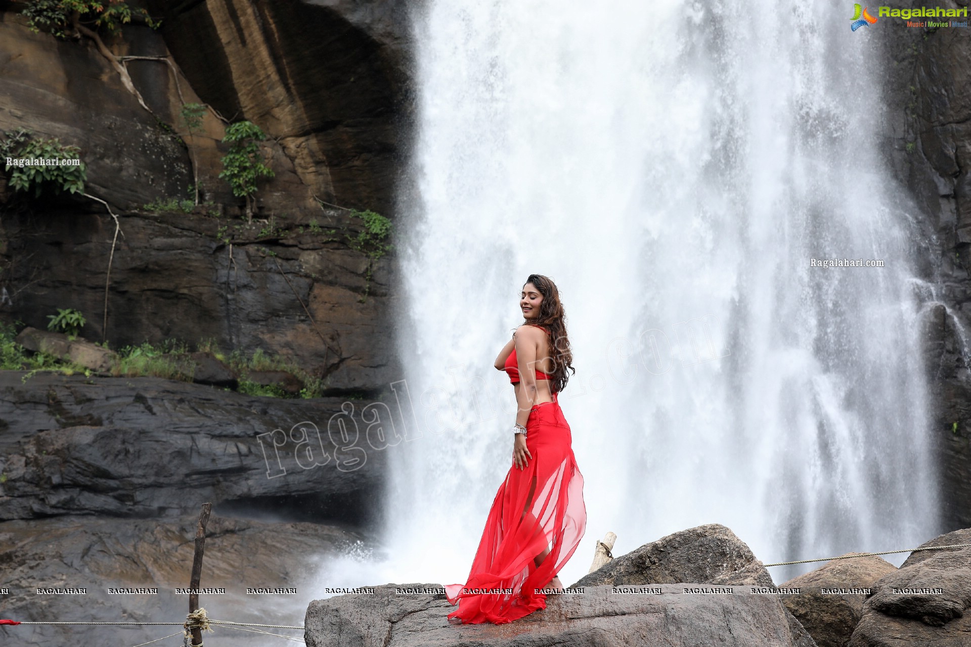 Payal Rajput Posing Provocatively in a Red Flowing Dress at a Waterfall, Exclusive