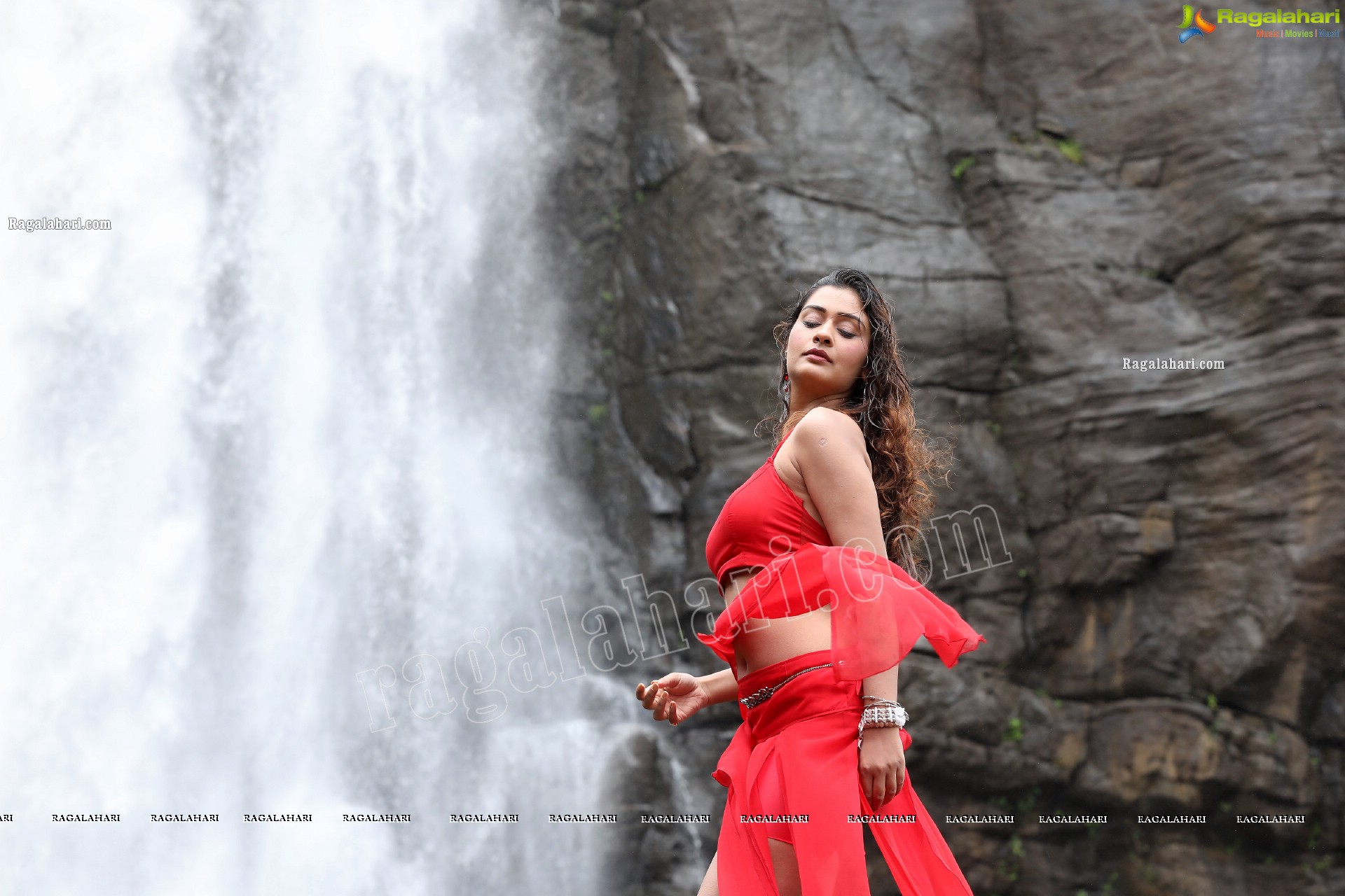 Payal Rajput Posing Provocatively in a Red Flowing Dress at a Waterfall, Exclusive