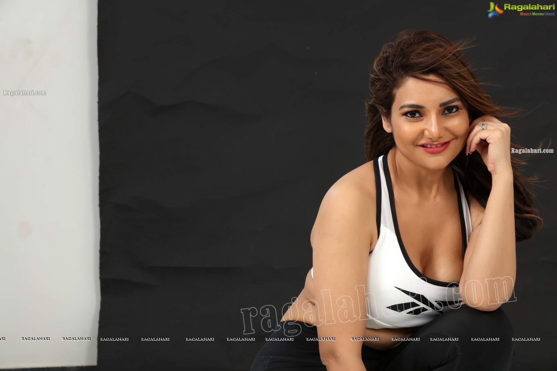 Nisha Singh Rajput in Black Package Hip Mini Skirt and White Spaghetti Strap Crop Top Exclusive Photo Shoot