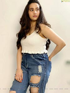 Manjusha in White Smocked Crop Top and Ripped Jeans