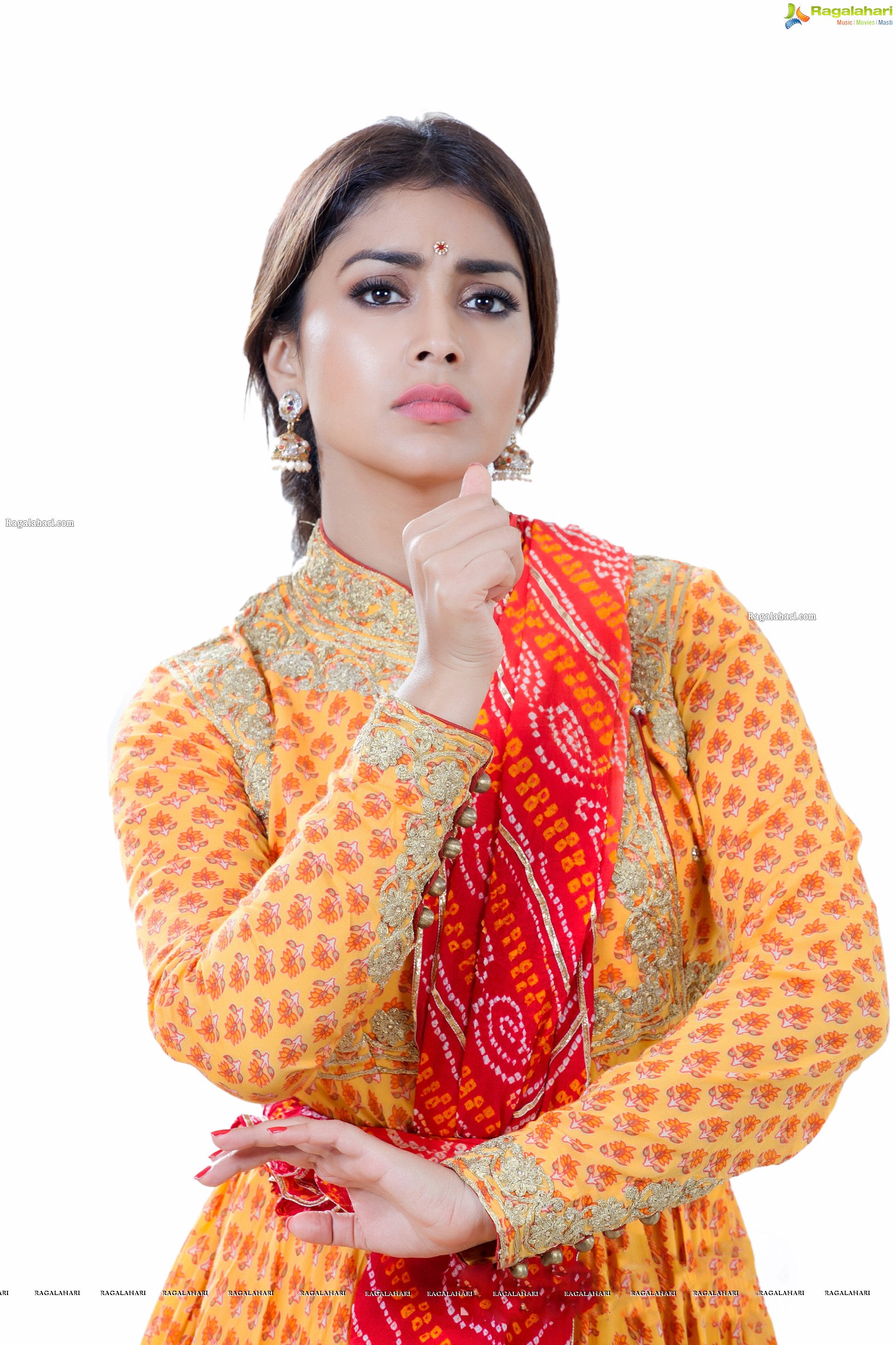 Shriya Saran in Dance Poses Adorning a Yellow Churidar