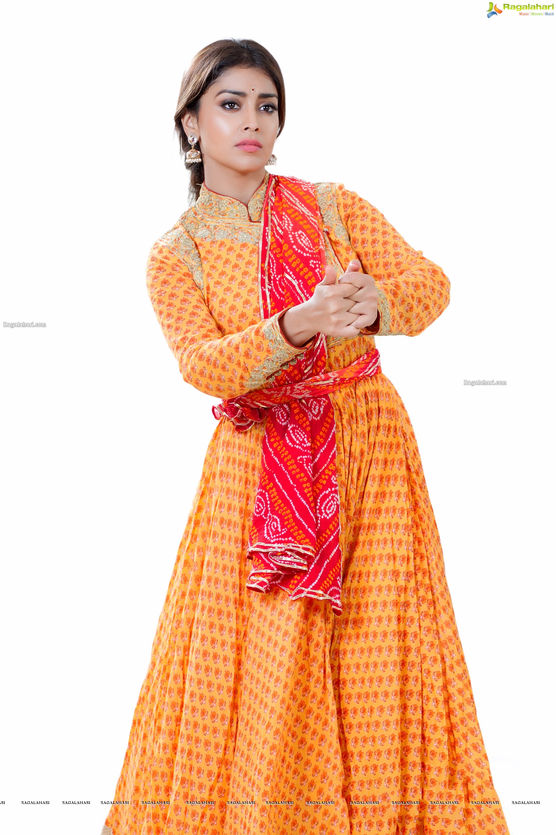 Shriya Saran in Dance Poses Adorning a Yellow Churidar