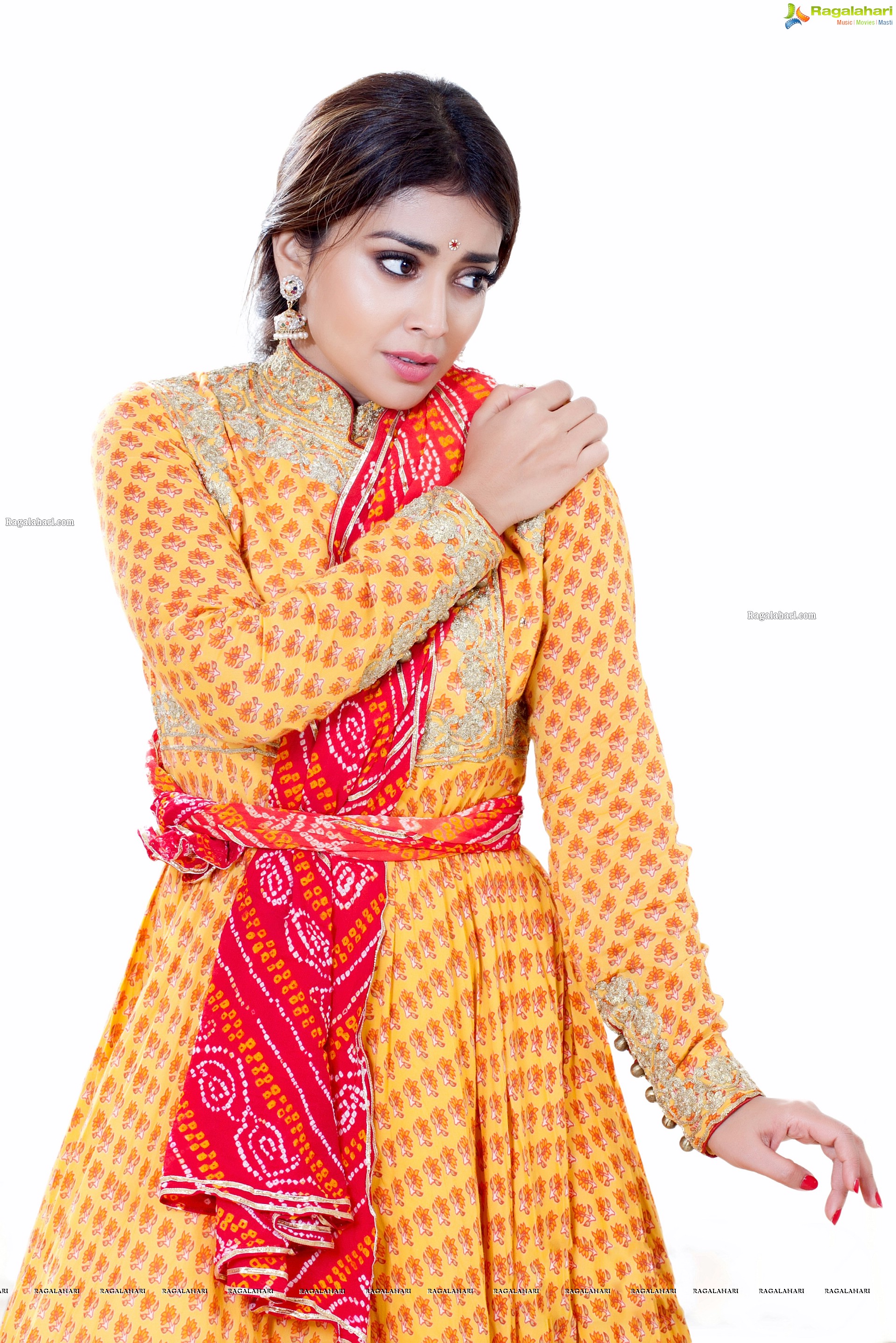 Shriya Saran in Dance Poses Adorning a Yellow Churidar