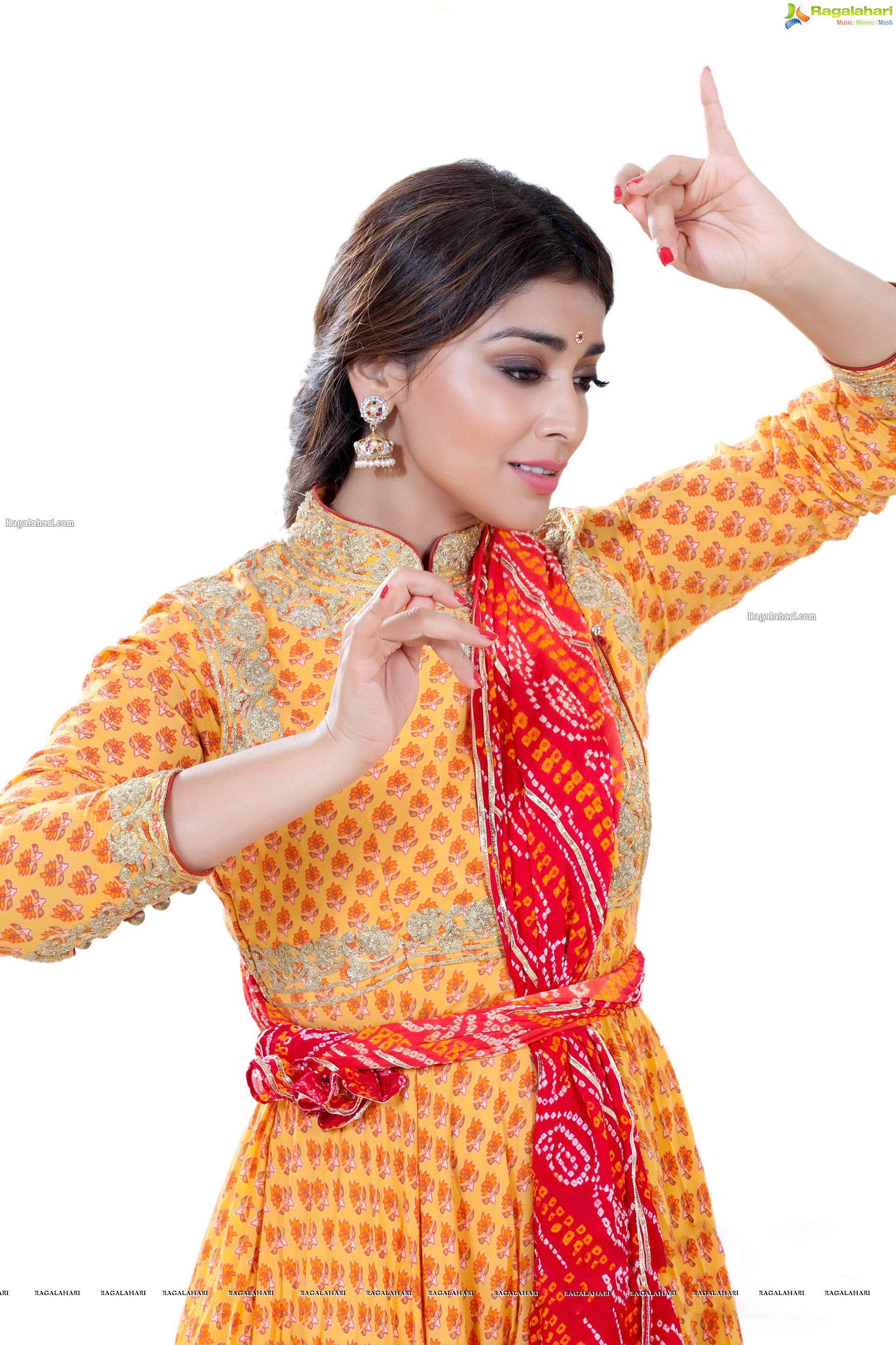 Shriya Saran in Dance Poses Adorning a Yellow Churidar