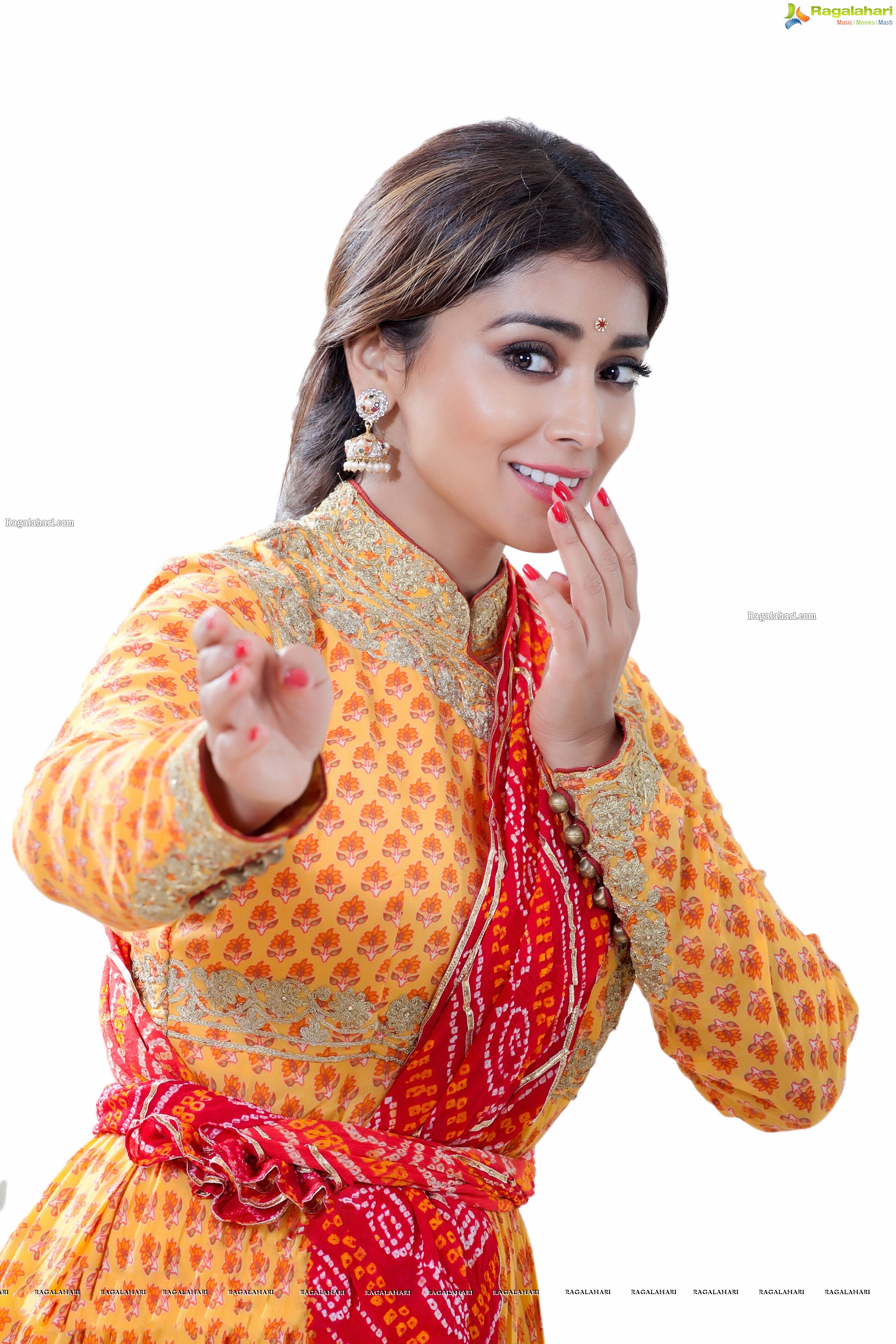 Shriya Saran in Dance Poses Adorning a Yellow Churidar