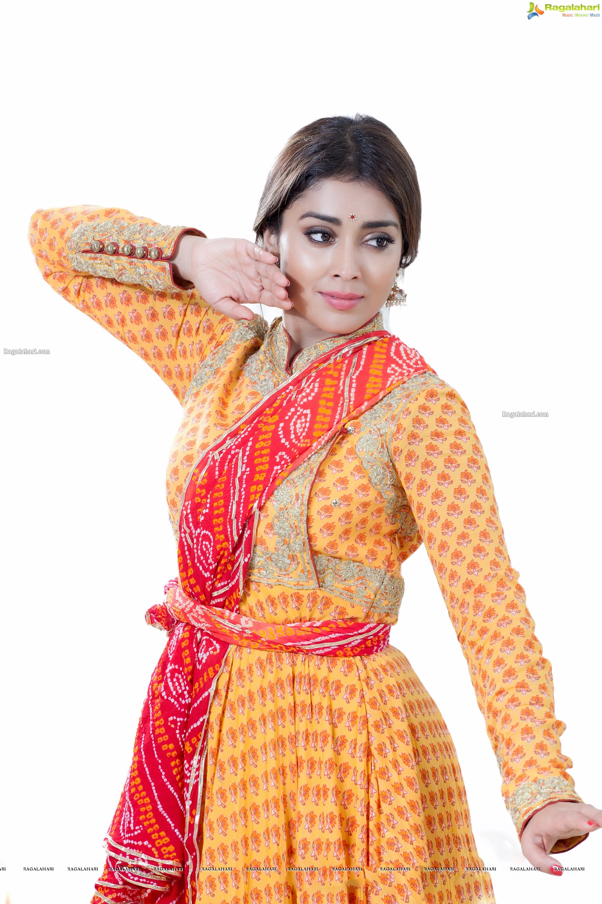 Shriya Saran in Dance Poses Adorning a Yellow Churidar