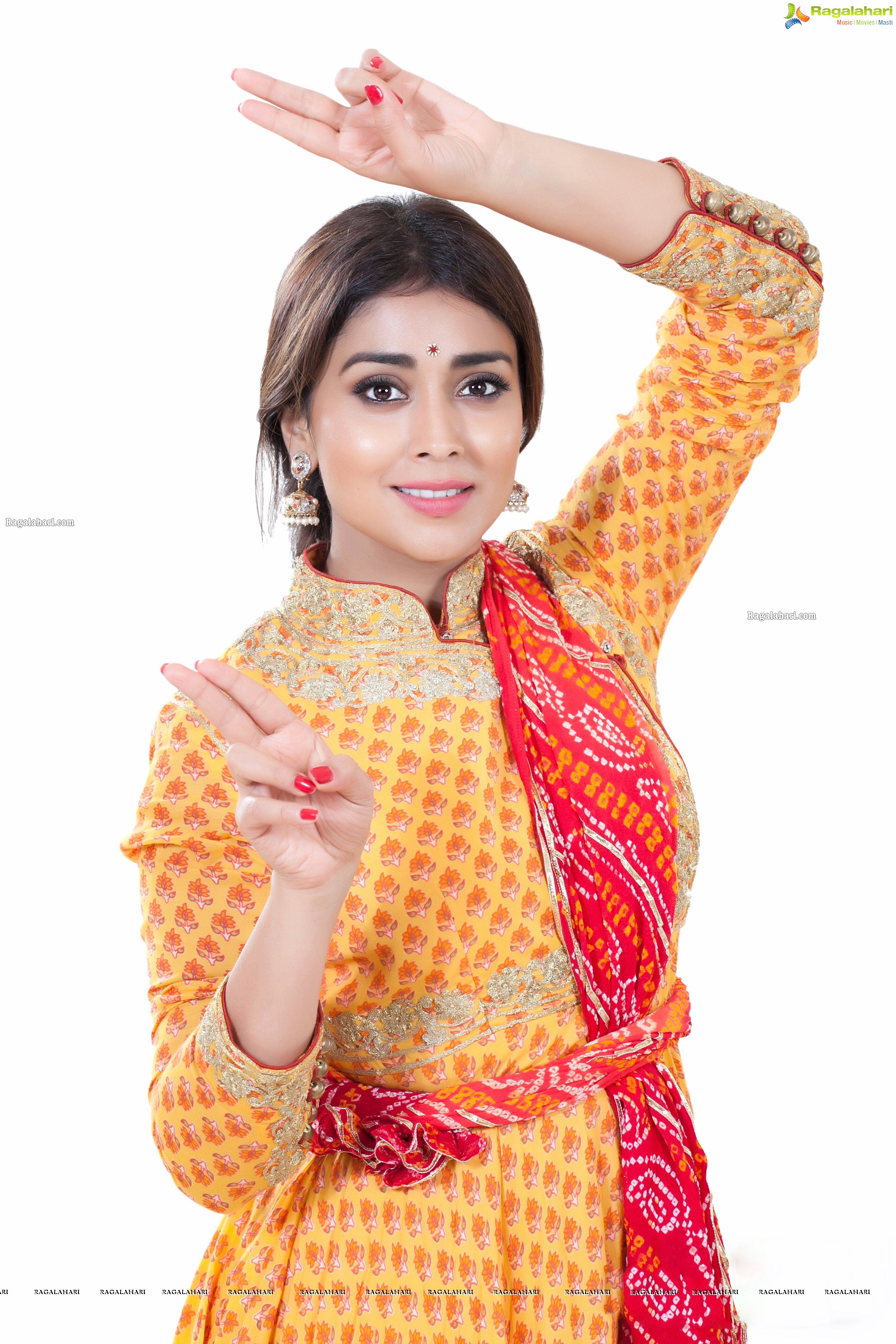 Shriya Saran in Dance Poses Adorning a Yellow Churidar