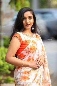 Sruthi in White-Orange Floral Print Saree