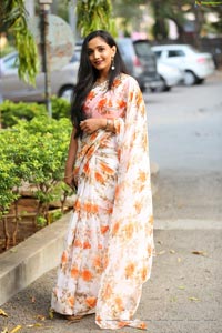 Sruthi in White-Orange Floral Print Saree