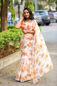 Sruthi in White-Orange Floral Print Saree