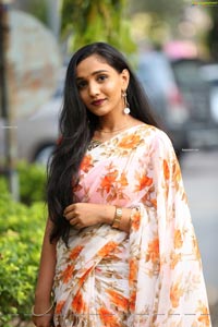 Sruthi in White-Orange Floral Print Saree